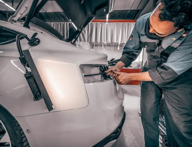 An Expert Repairing White Car Backlight
