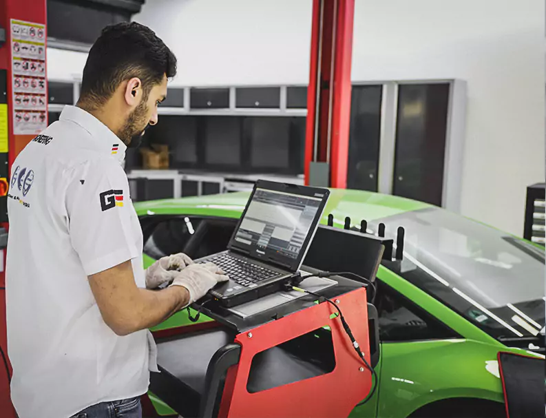 A German Expert Scanning the Car Problem on Laptop